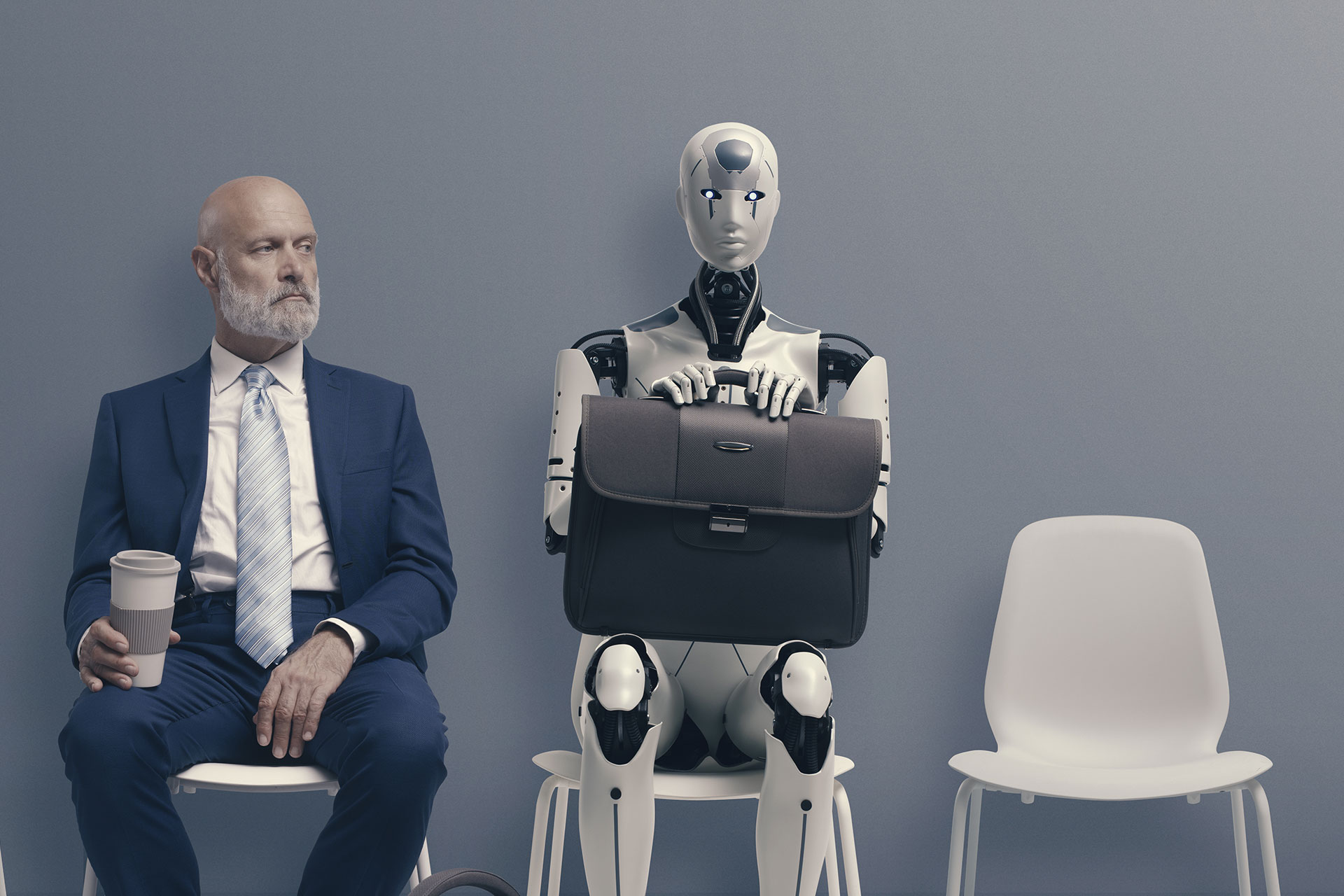 Robot sitting next to man with coffee to interview for AI marketing job