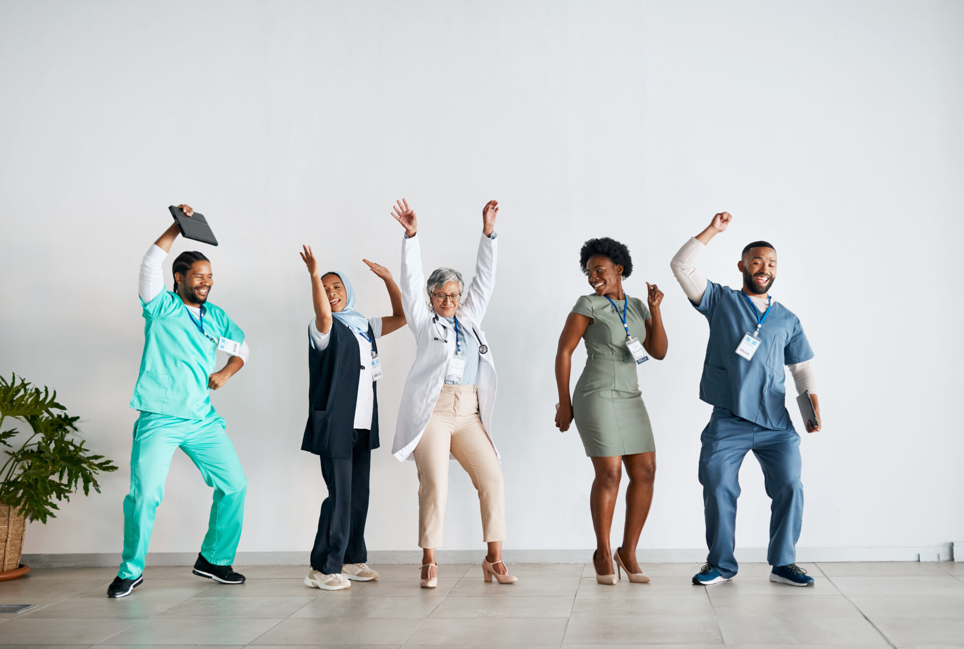 People in medical clothing dancing excited